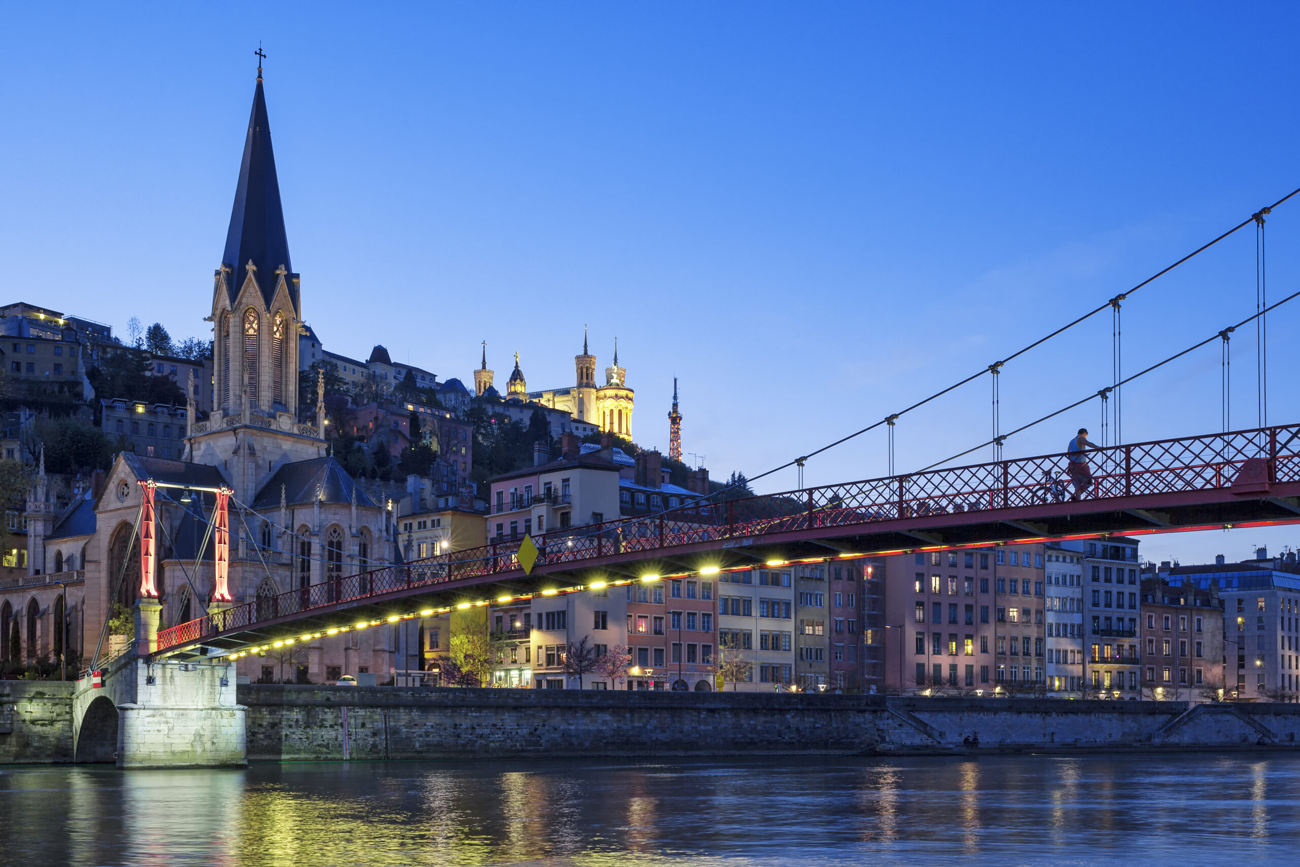 Famous view of church in Lyon with Saone river at night