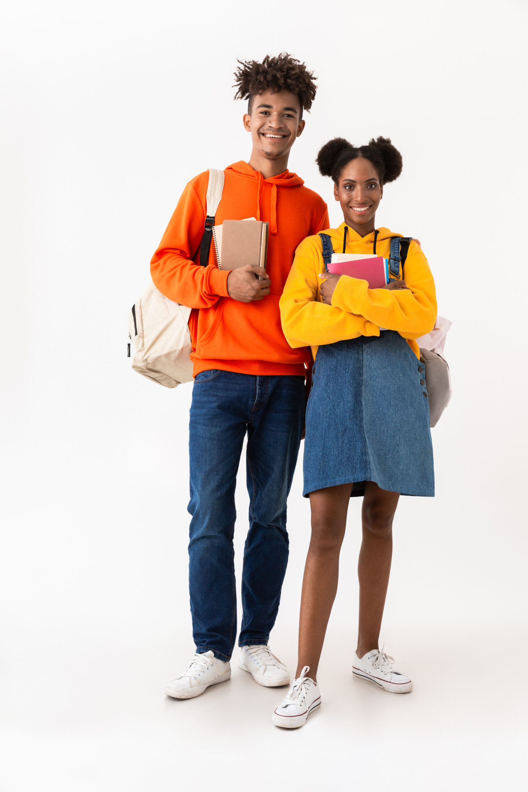 Full length photo of african american students in colorful clothes holding exercise books isolated over white background